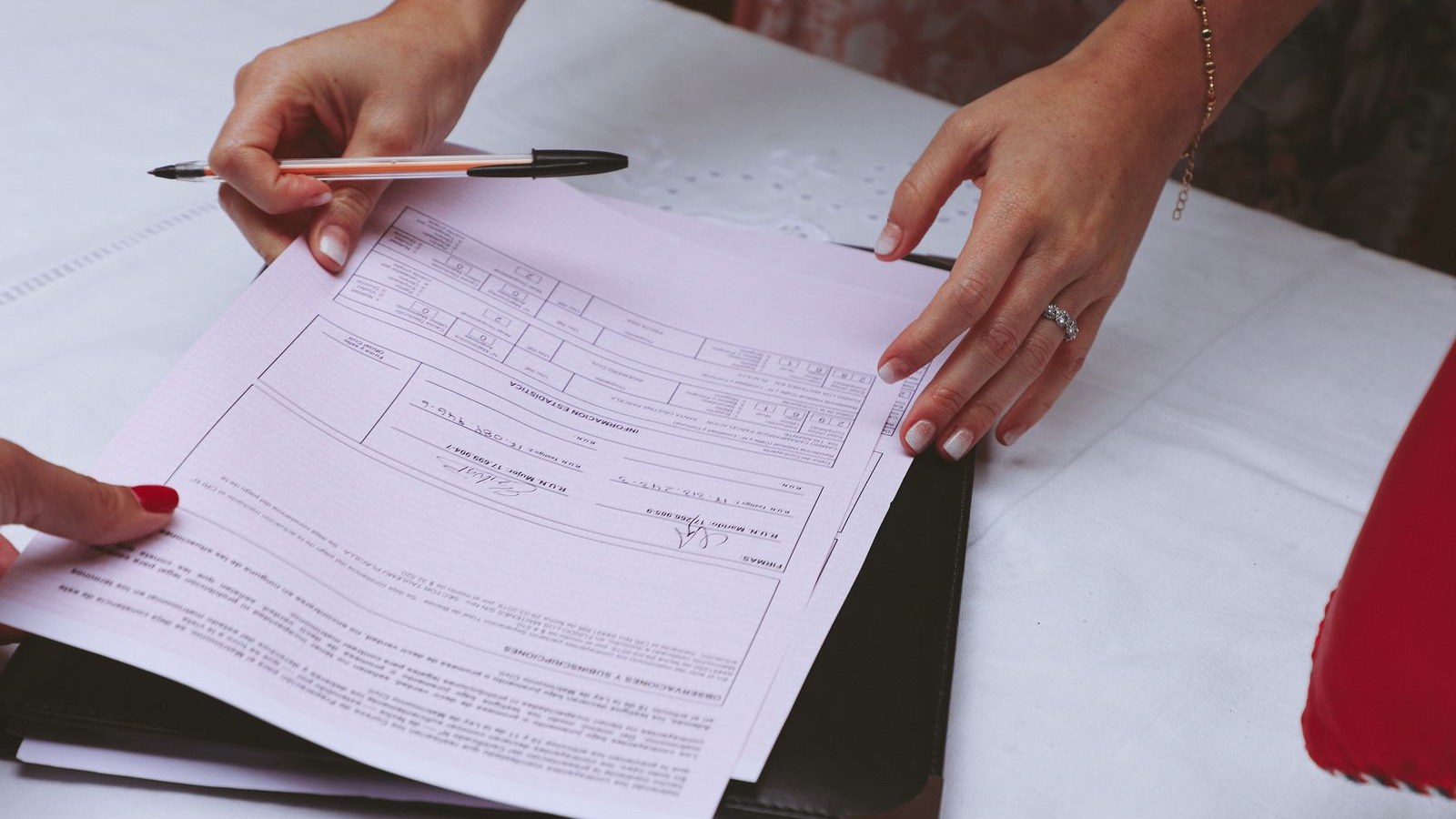 A two-page printed plan on a desk with a blank signature line at the bottom